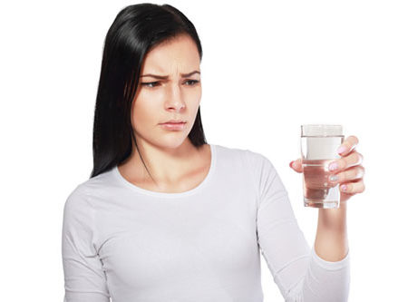 woman looking at water looking unhappy or disgusted