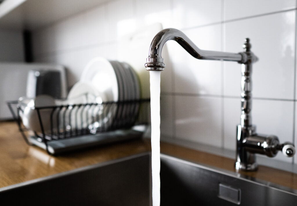 Clean water running from a kitchen faucet.