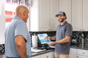 An Atlantic Blue technician talking with a customer about water treatment in Calvert County