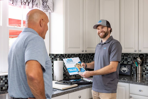 An Atlantic Blue technician talking with a customer about water treatment in Calvert County
