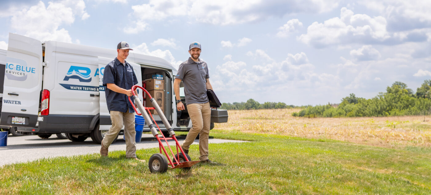 Atlantic Blue Water Services technicians pushing dolly
